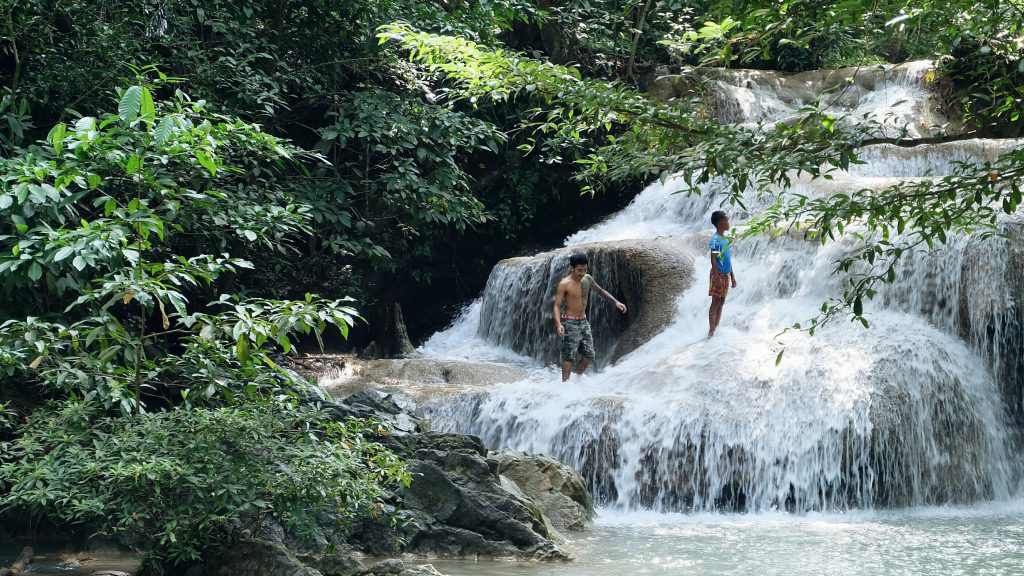 locals chasing waterfalls Erawan Falls Kanchanaburi