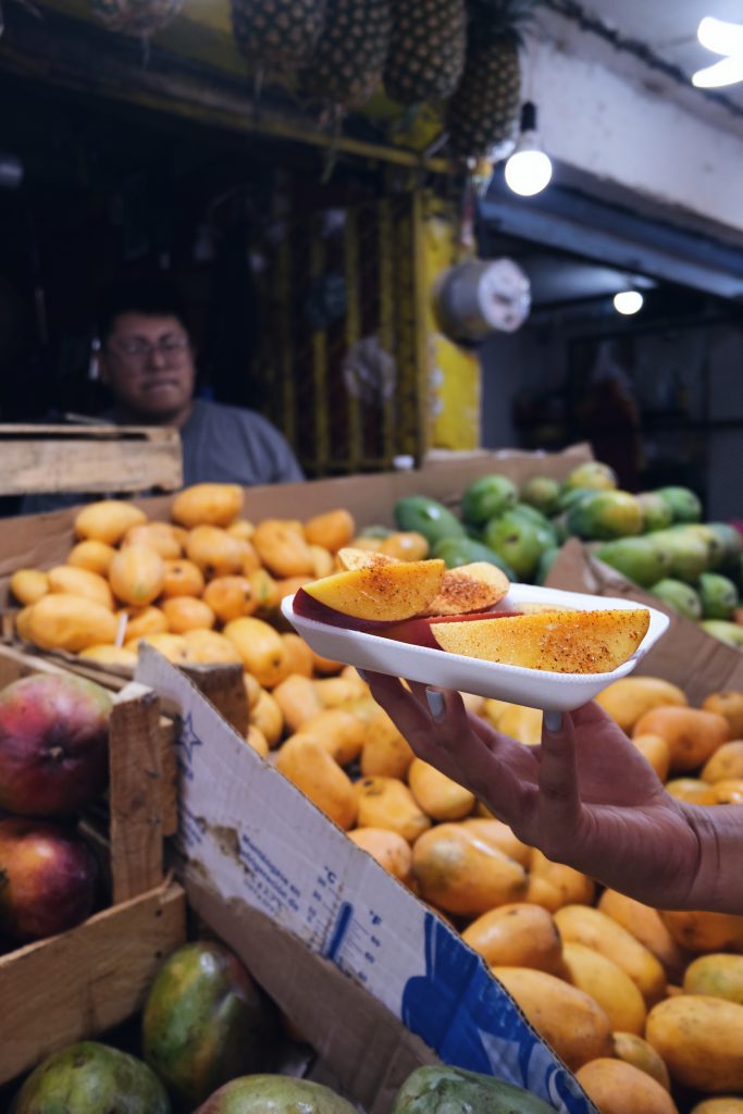 eating mango mercado Merida Mexico Yucatan dish