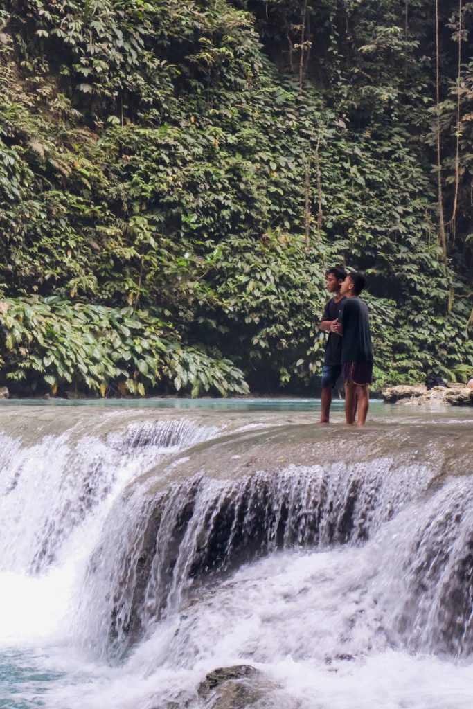 local boys waterfall nature Sulawesi